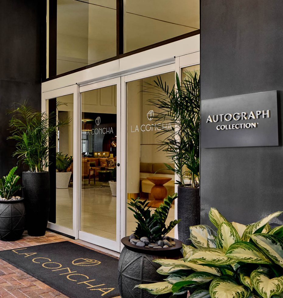 a front entrance to a building with plants