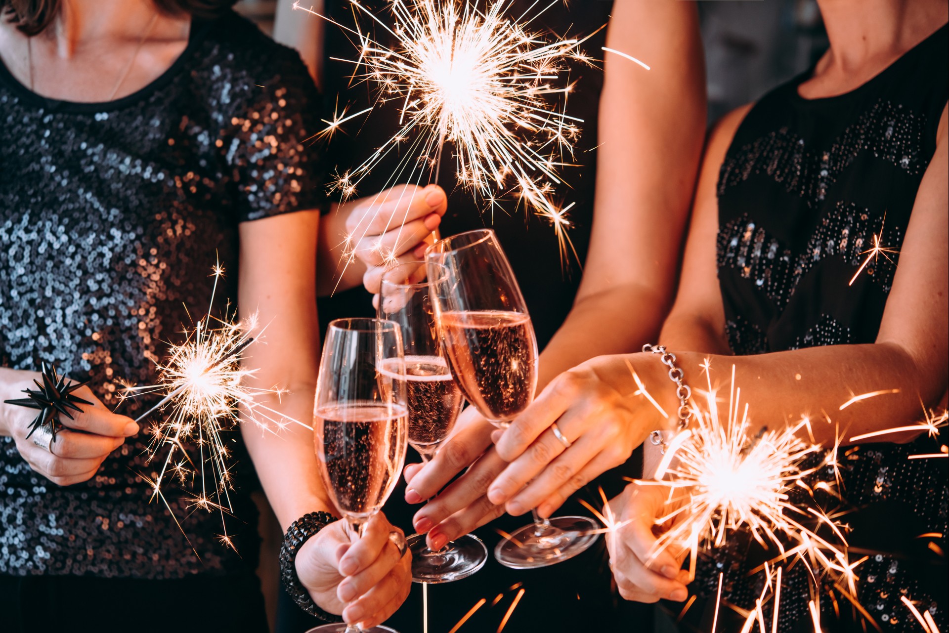 a group of people holding champagne glasses