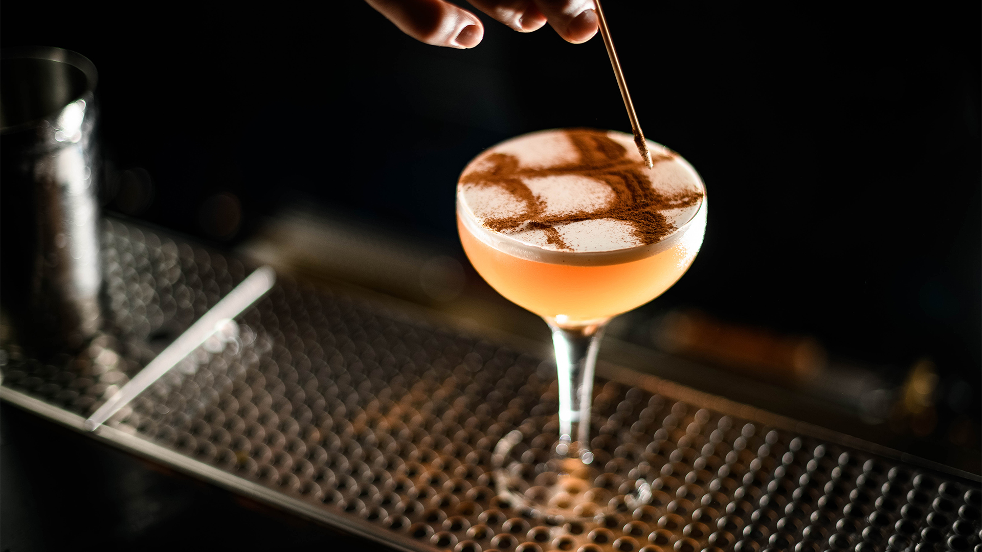 a glass of liquid with a straw