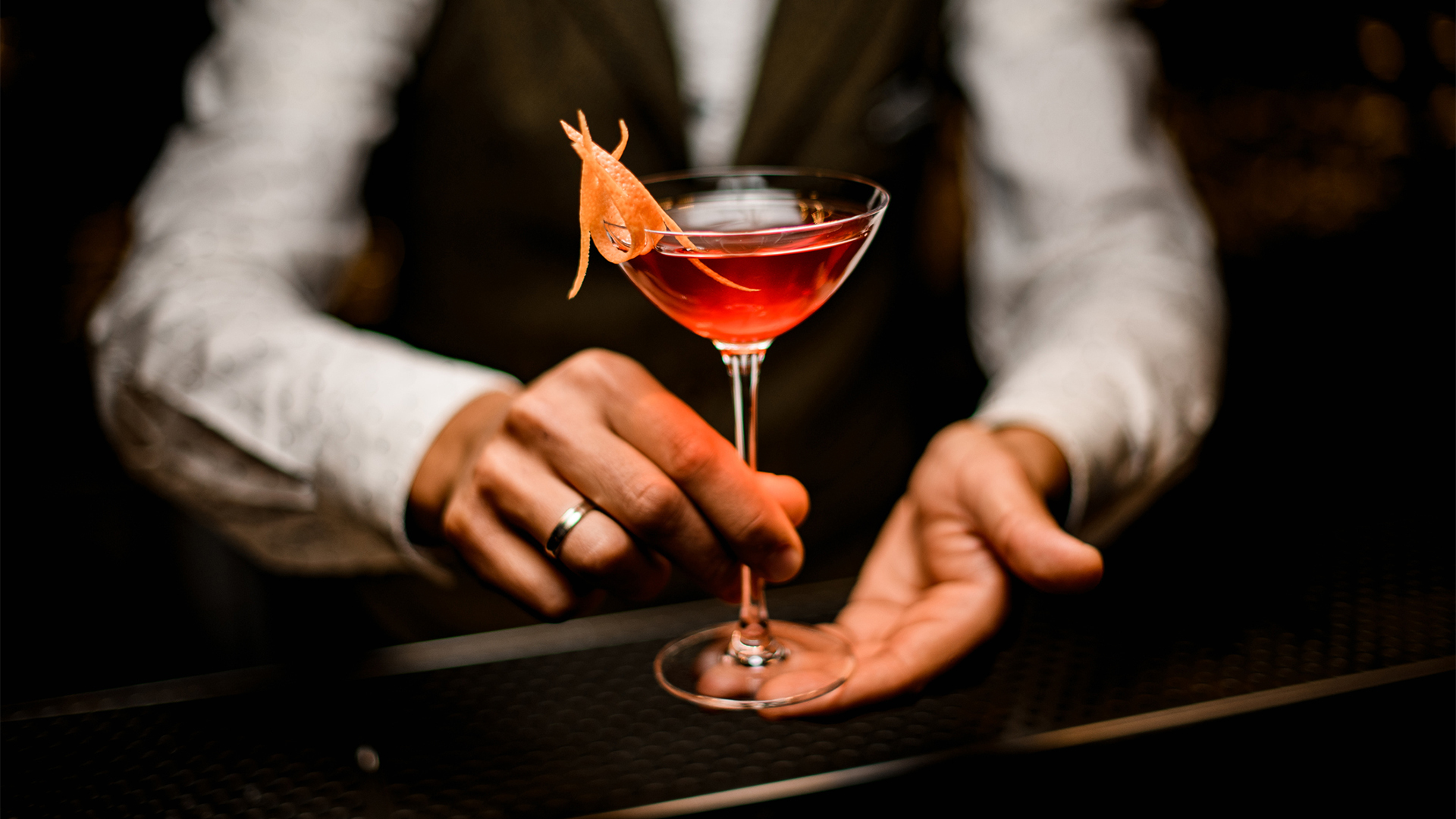 a person holding a red drink