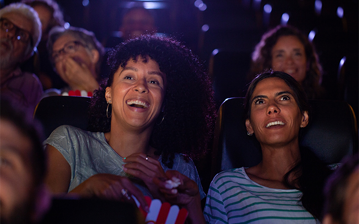 a group of people in a cinema smiling