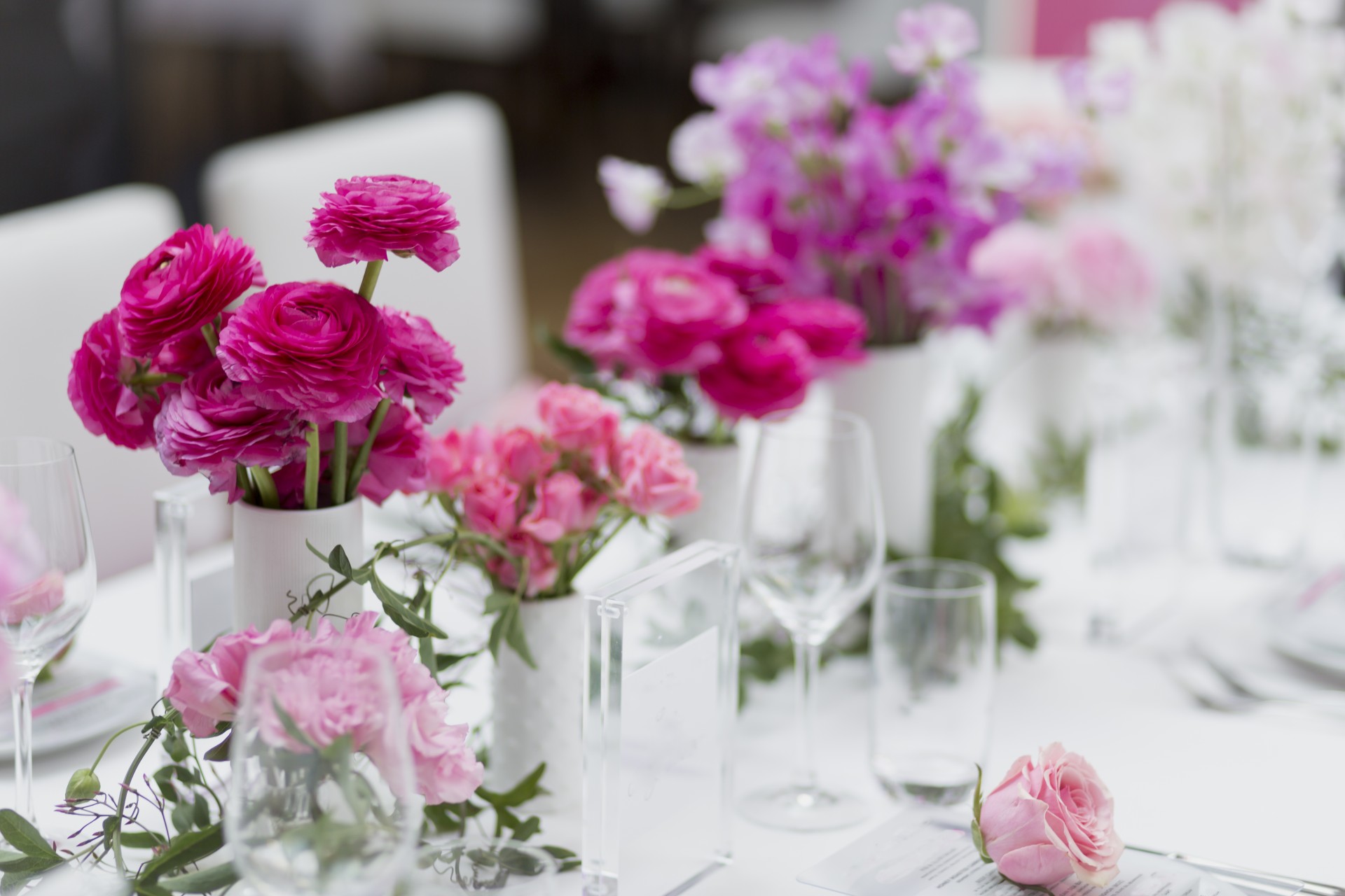 a table with flowers and glasses