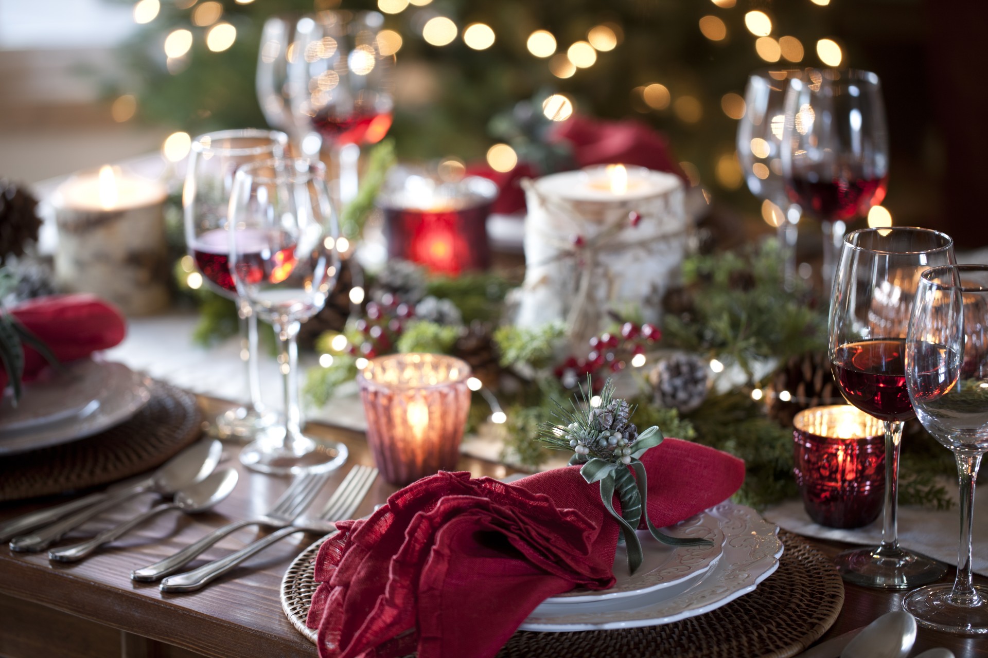 a table with plates and glasses and candles