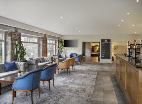 a room with chairs and a tv