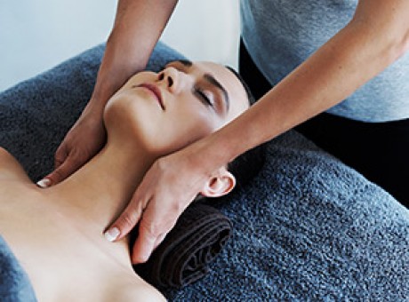 Woman doing a neck massage to a young lady