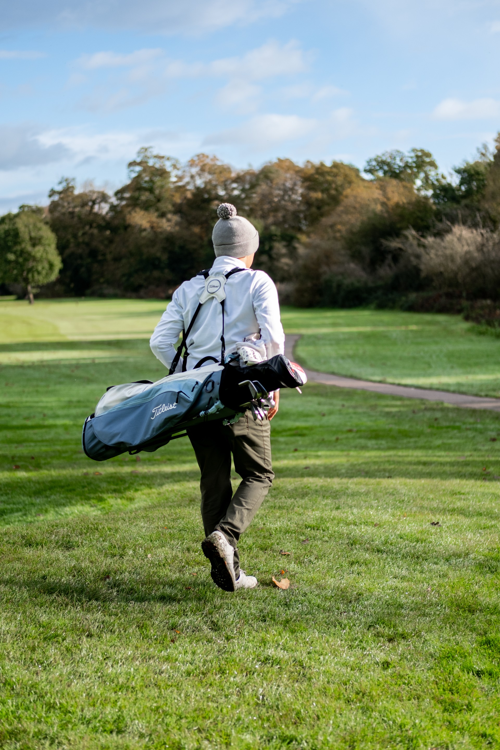 a person carrying a golf bag