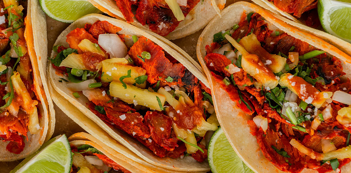 a group of tacos with meat and vegetables