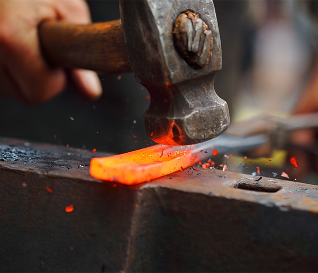 a hammer hitting a piece of metal with a hammer