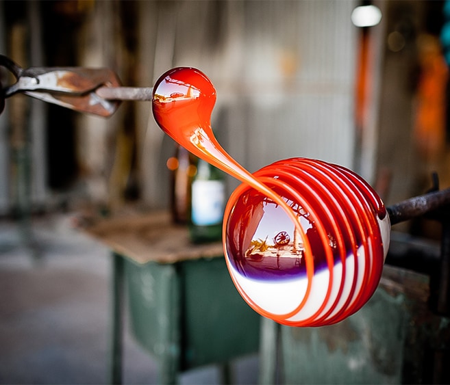 a glass ball with a red and white swirl