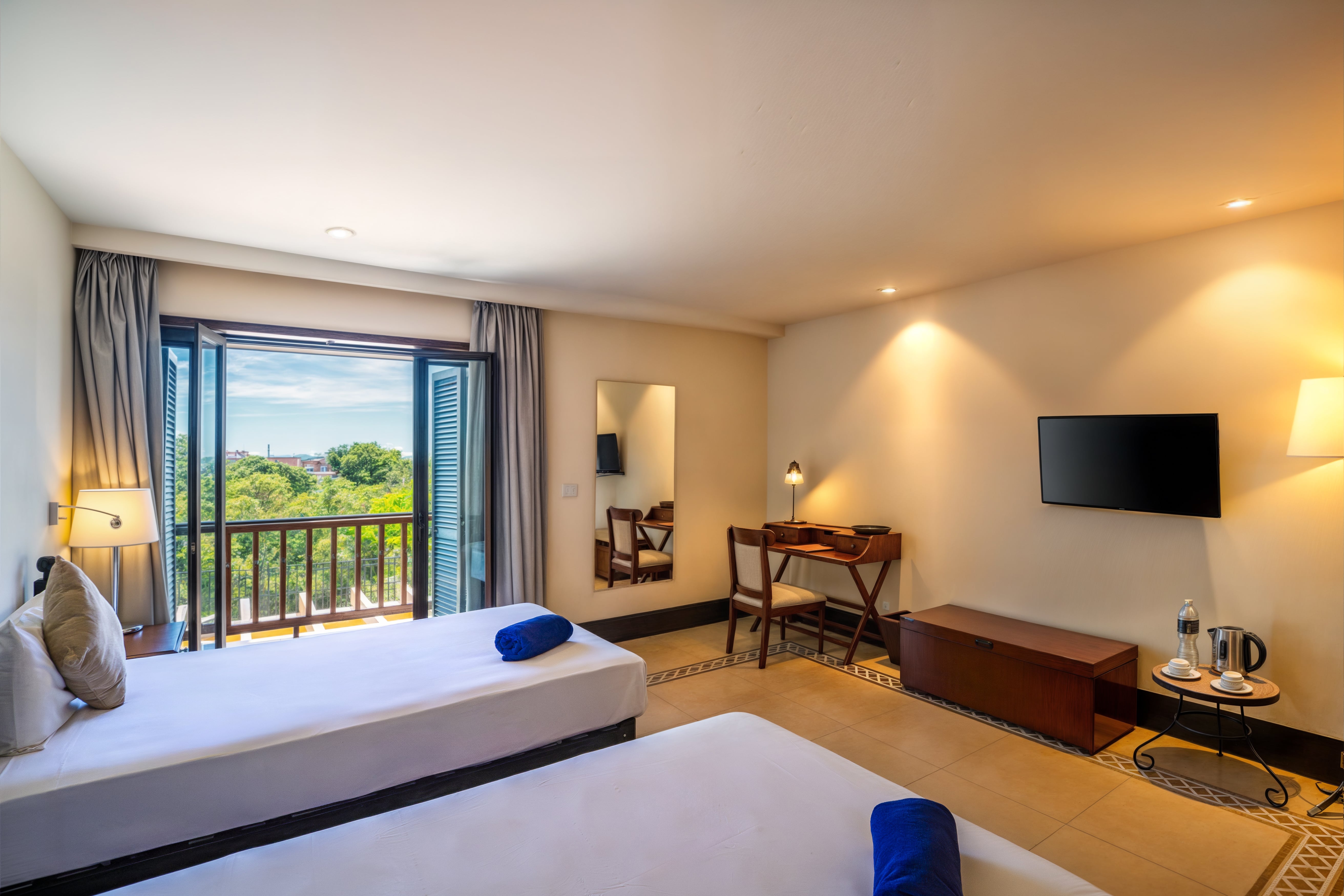 a room with two beds and a television