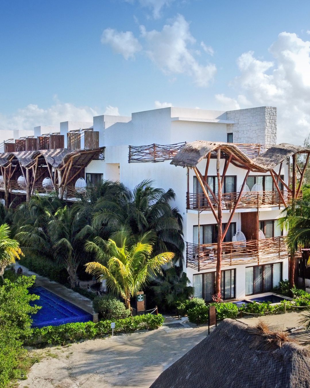a building with palm trees and a pool