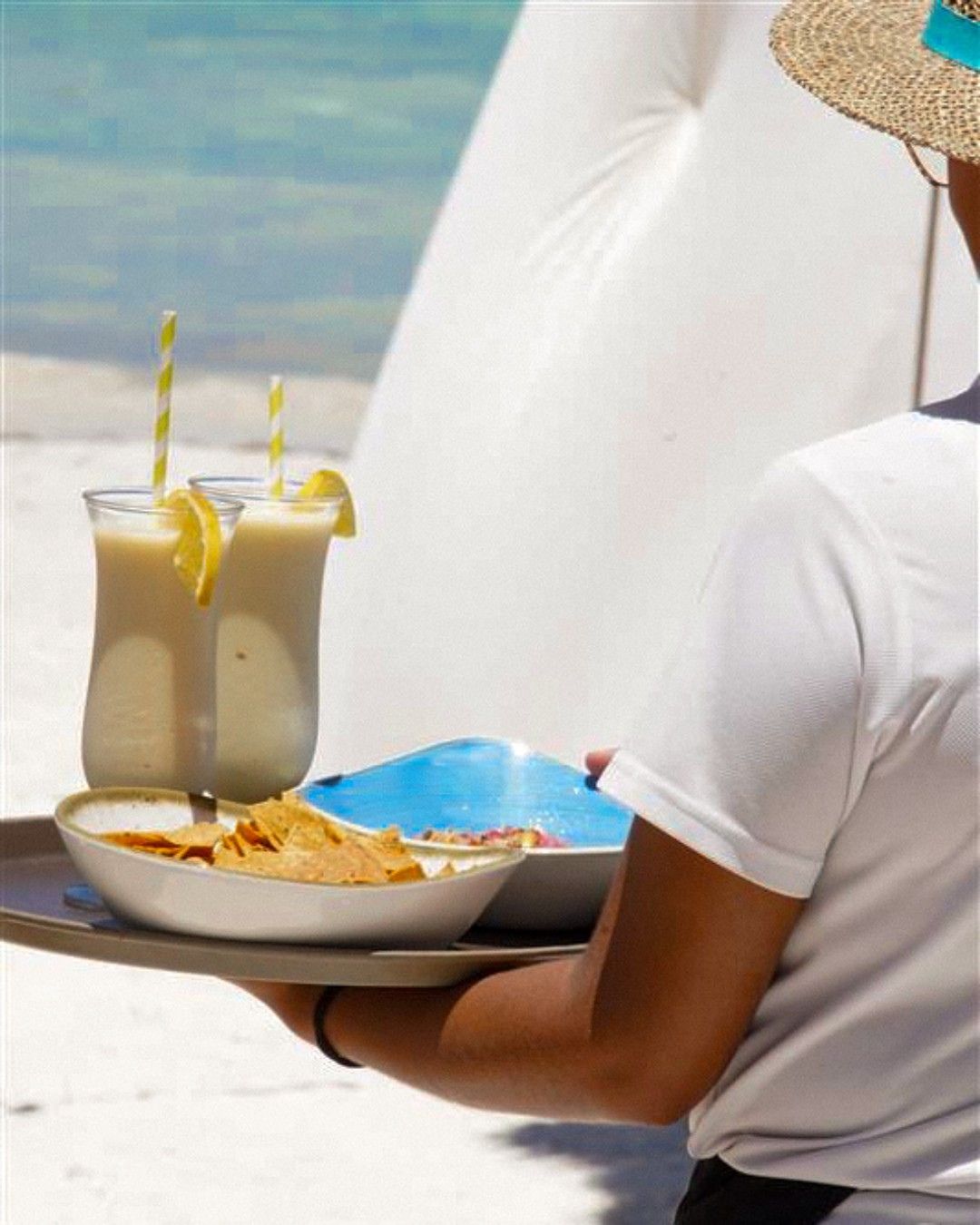 a person holding a tray with food on it