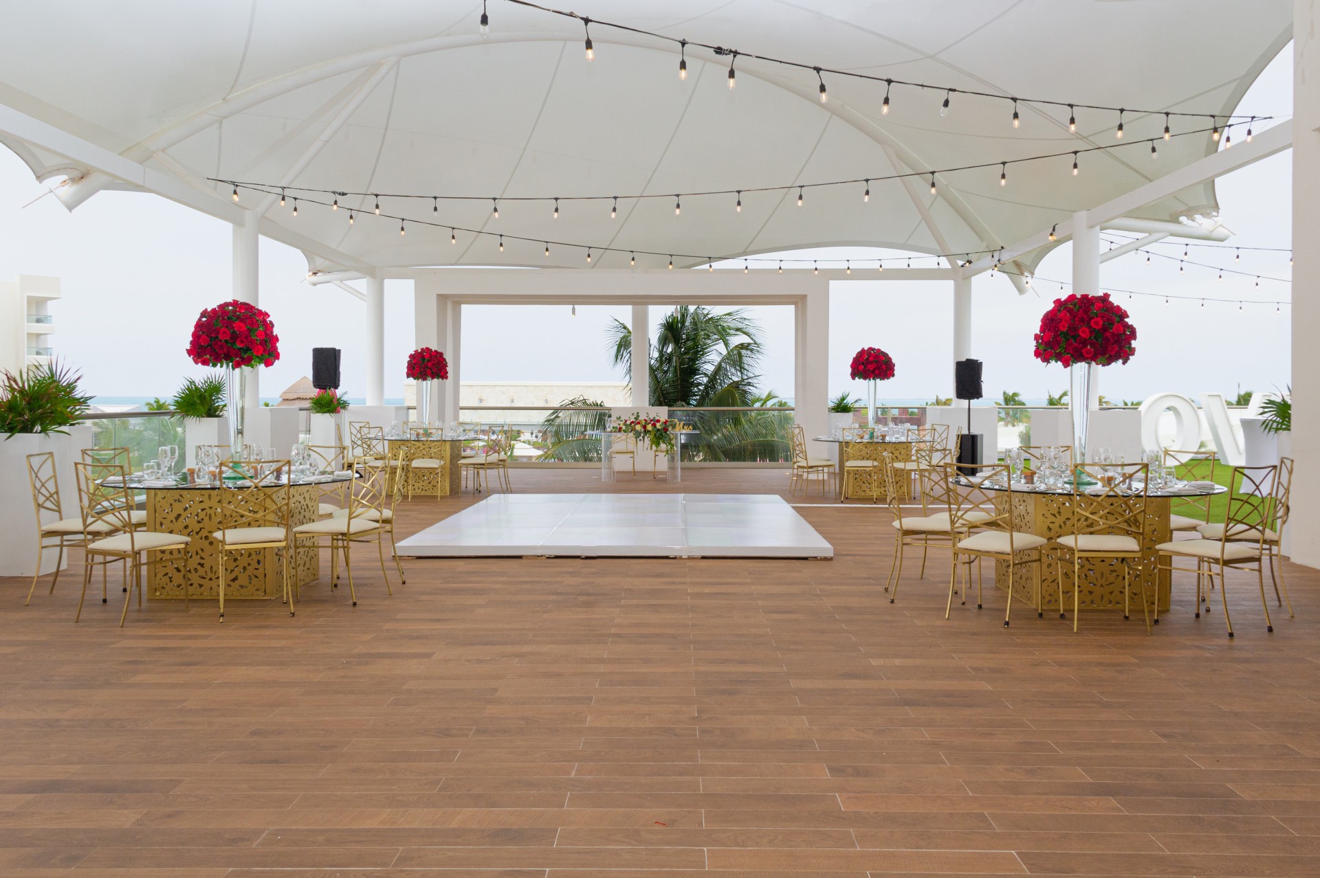 a large white tent with tables and chairs