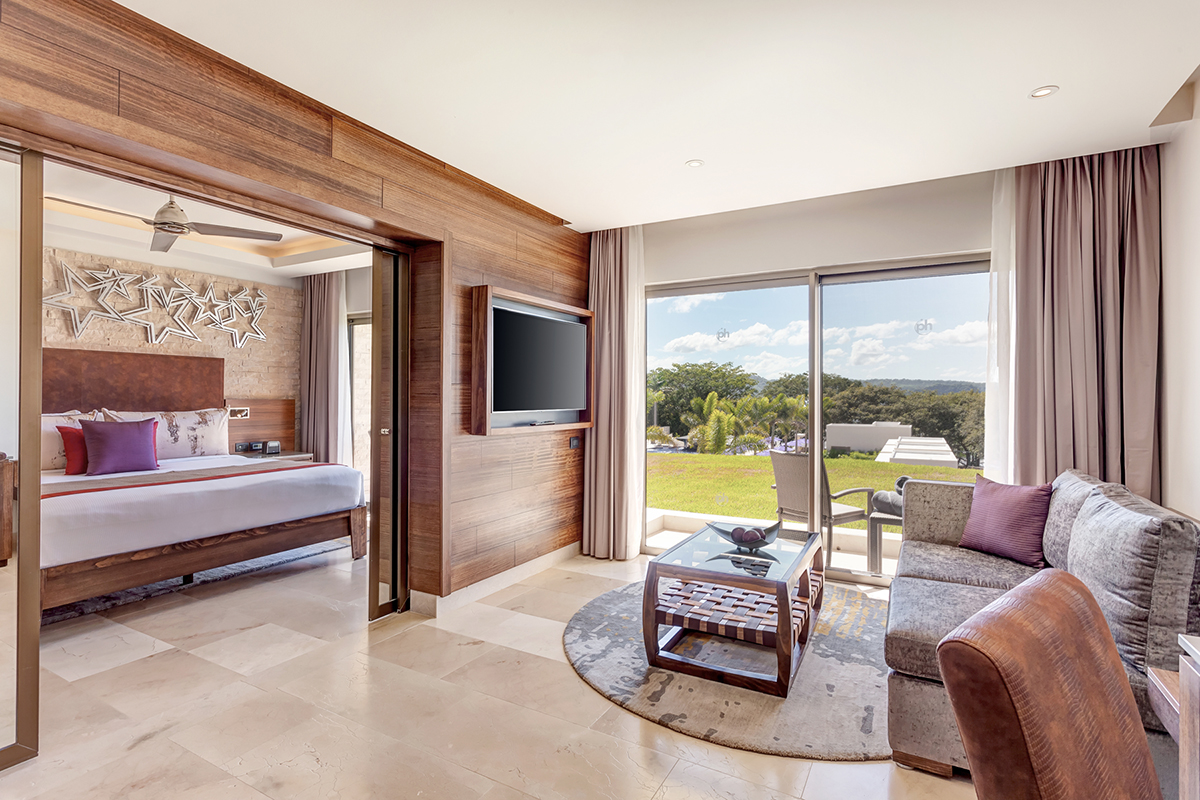 a room with a bed and a television