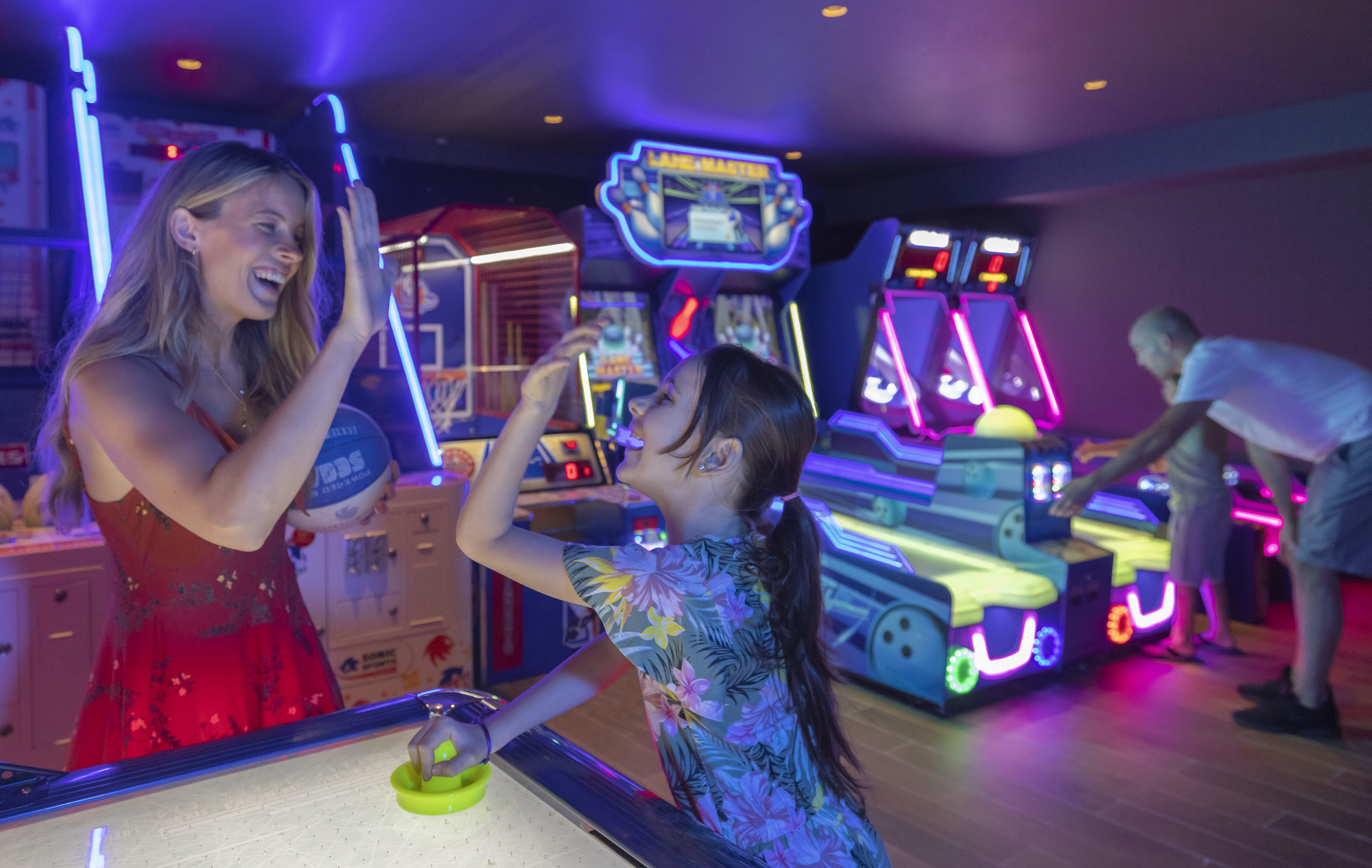 a woman and girl playing arcade games