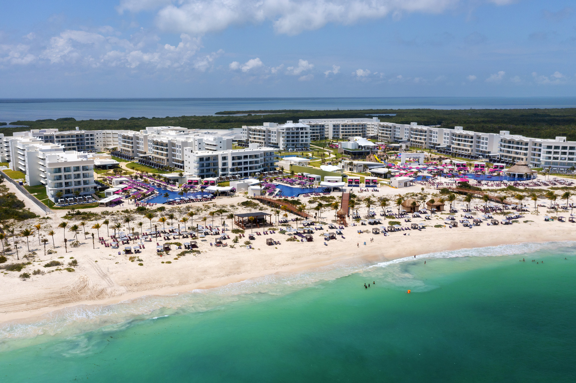 a beach with buildings and a body of water