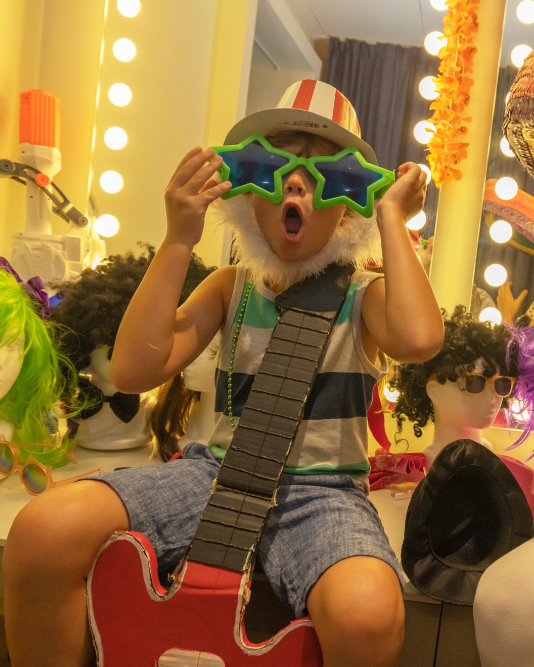 a child wearing a hat and sunglasses