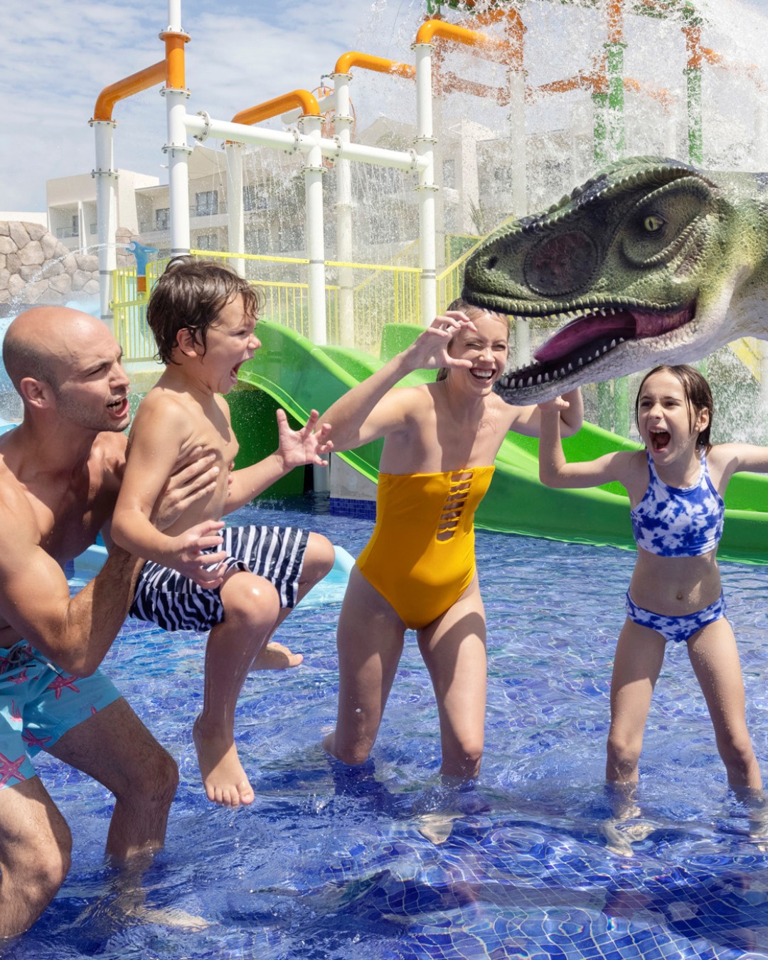 a group of people in a pool with a dinosaur head