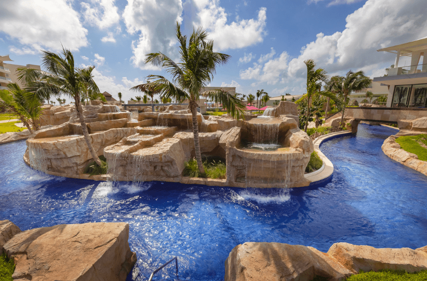 a pool with water and palm trees