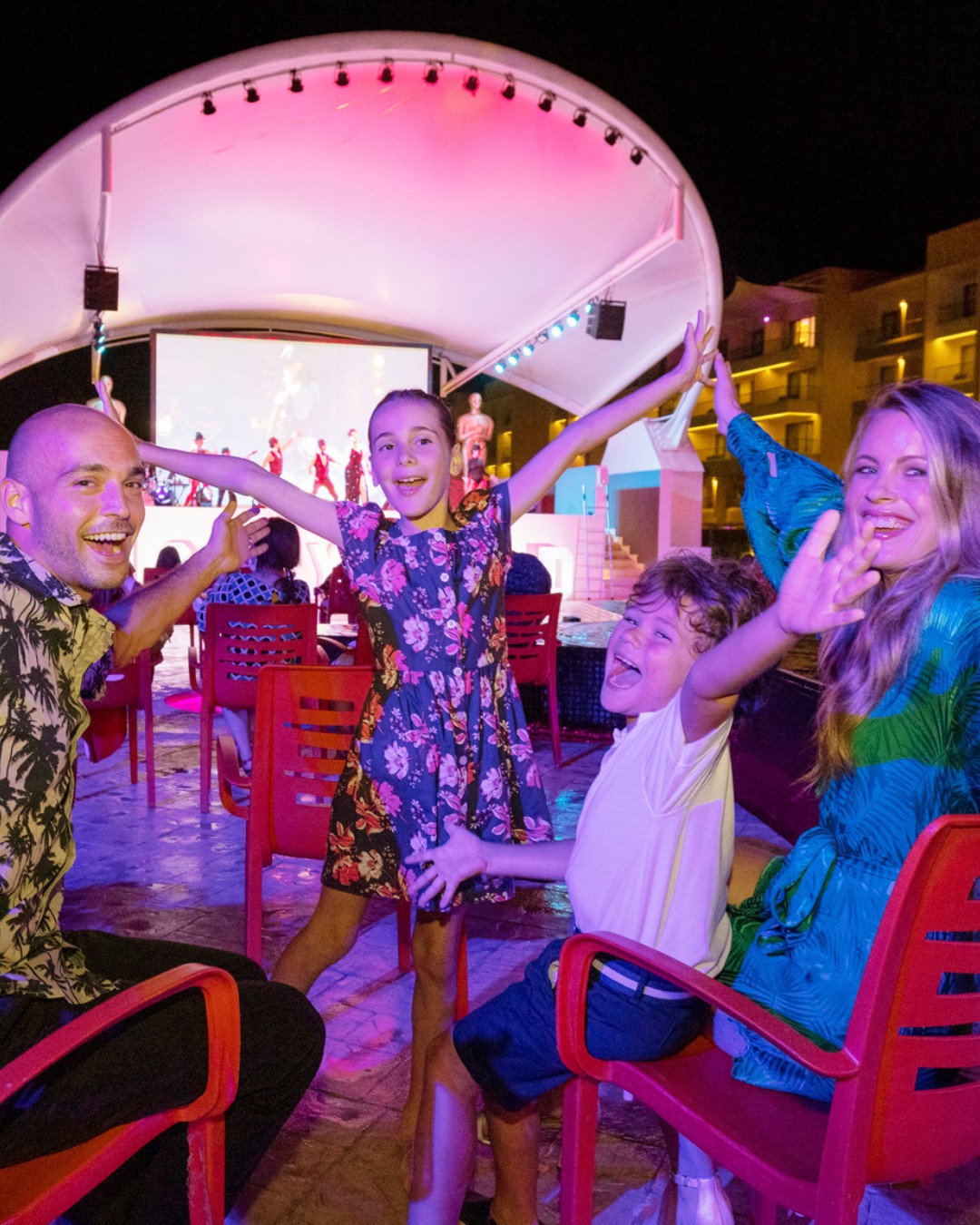 a group of people sitting under a tent