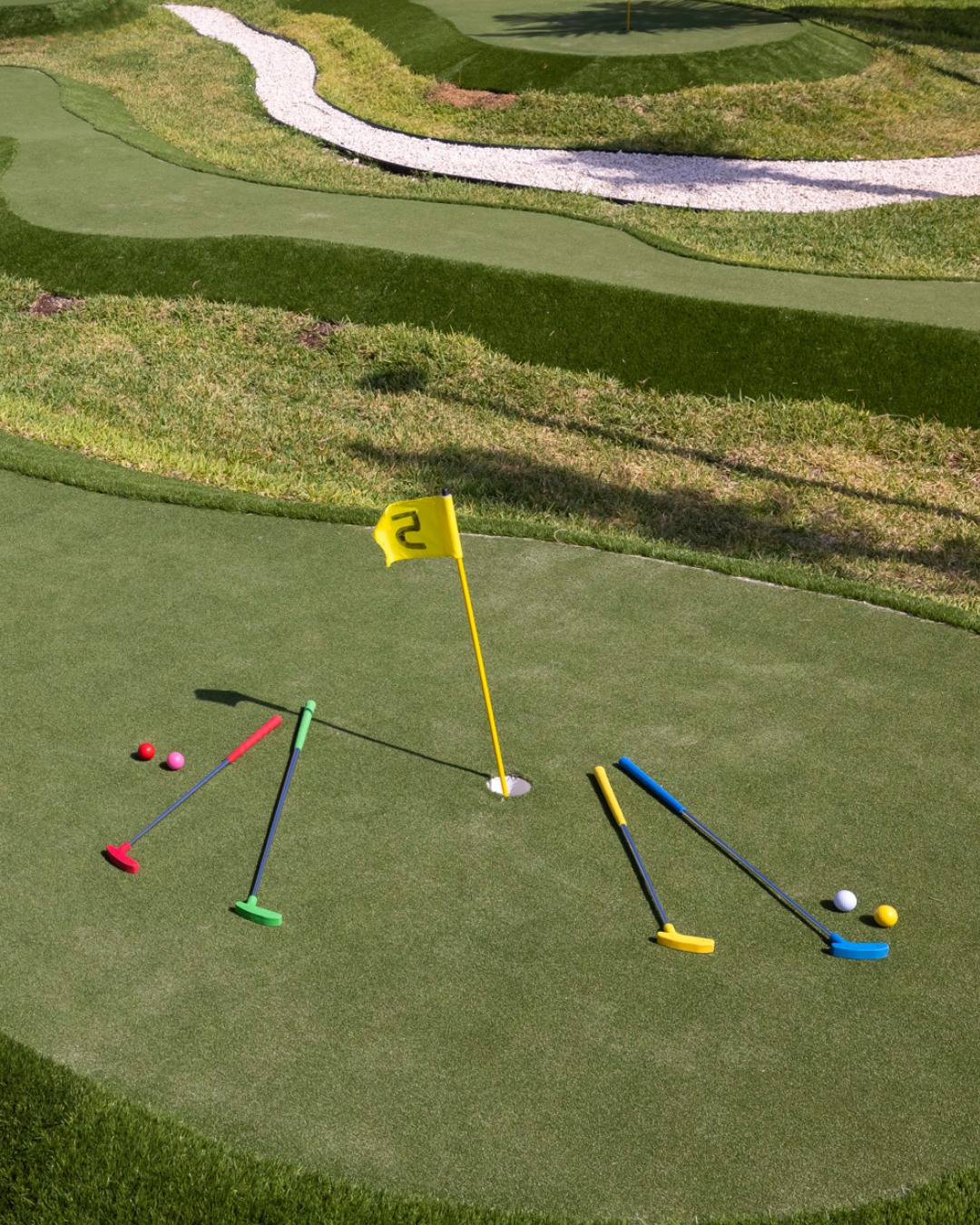 a golf club and flag on a green field