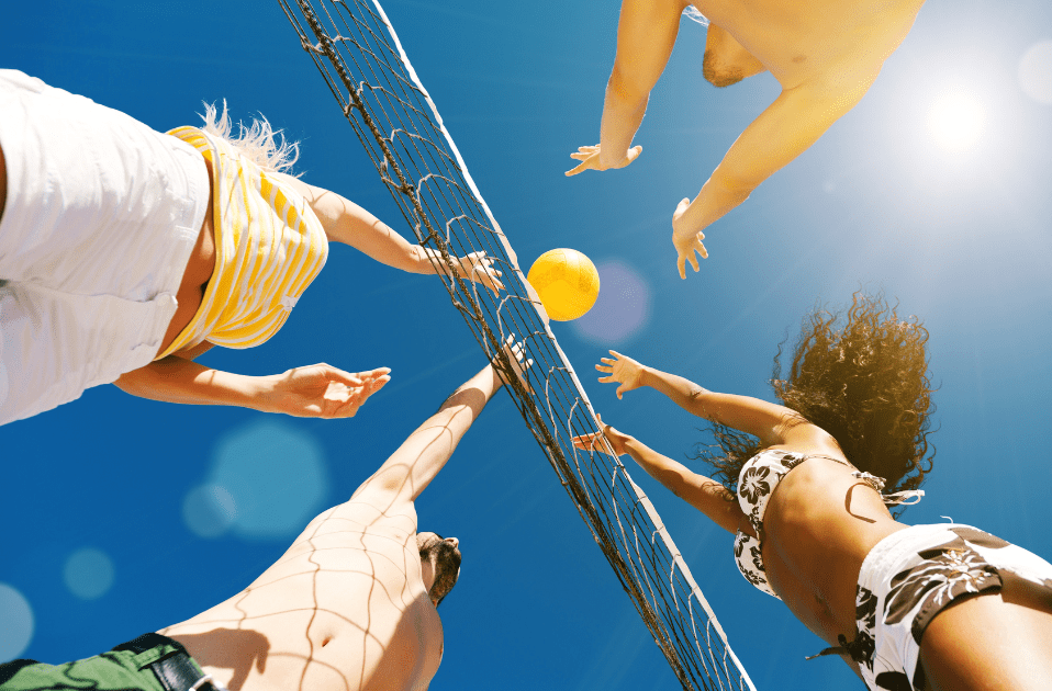 a group of people playing volleyball