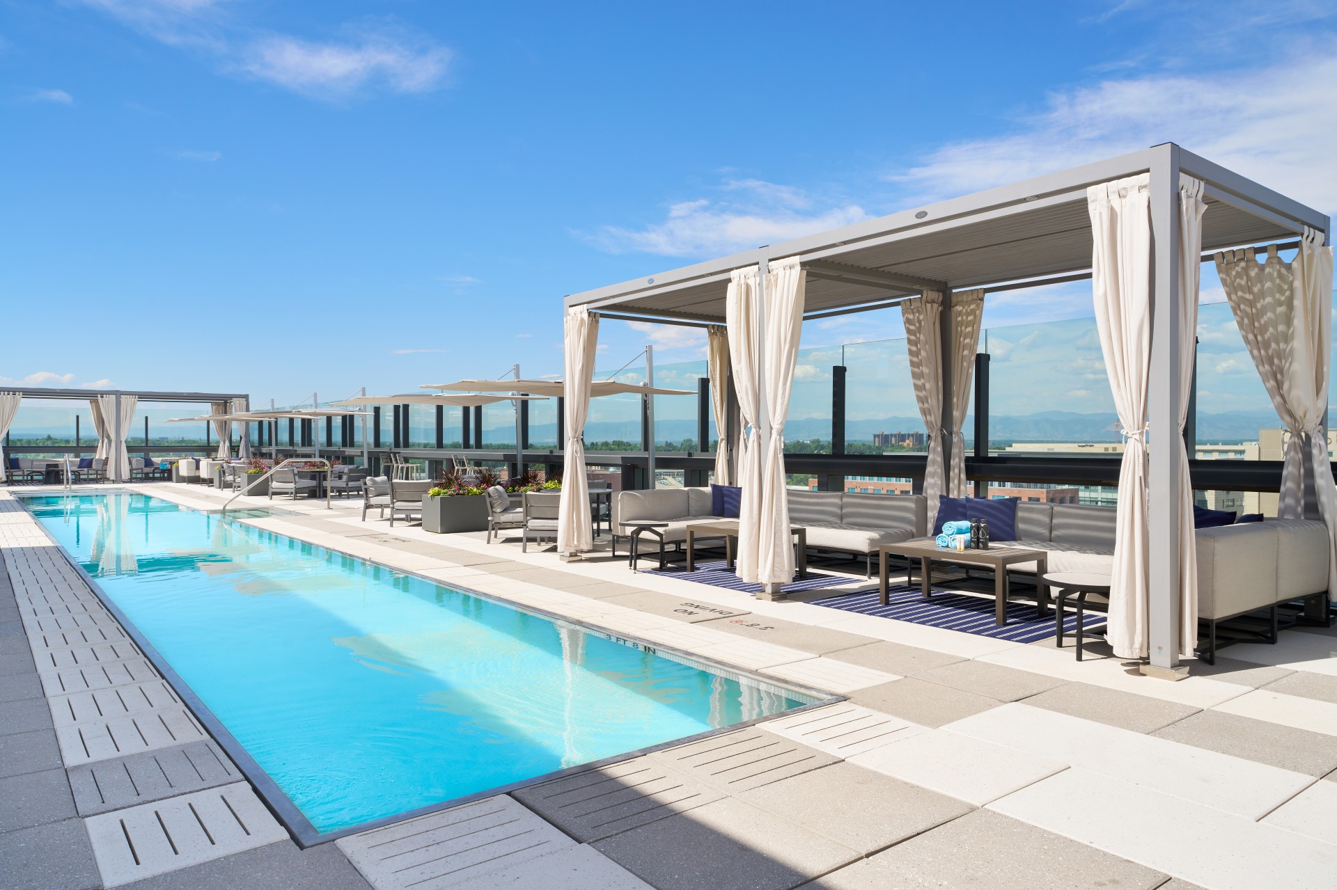 a pool with chairs and tables on a rooftop main