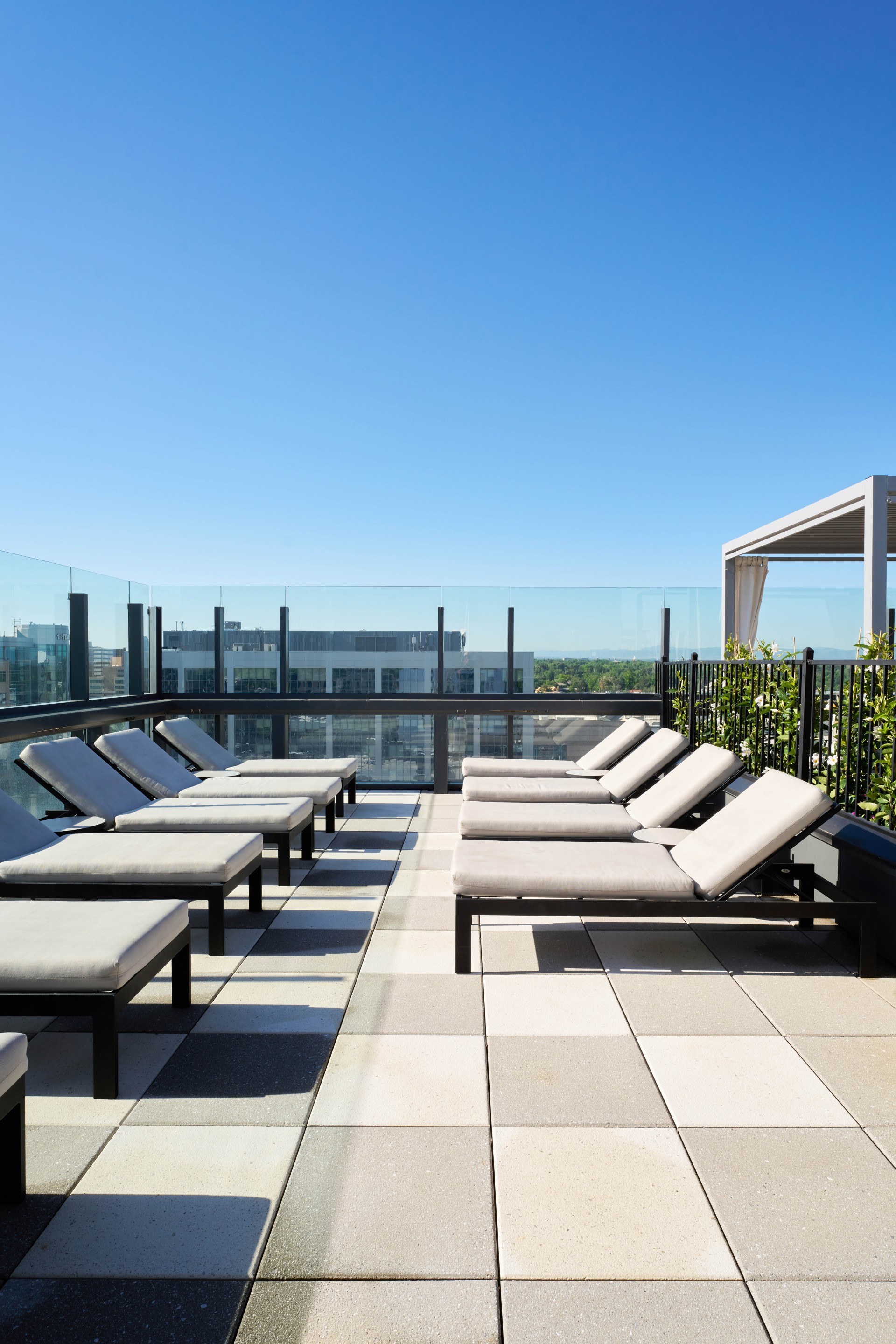 a group of lounge chairs on a rooftop main