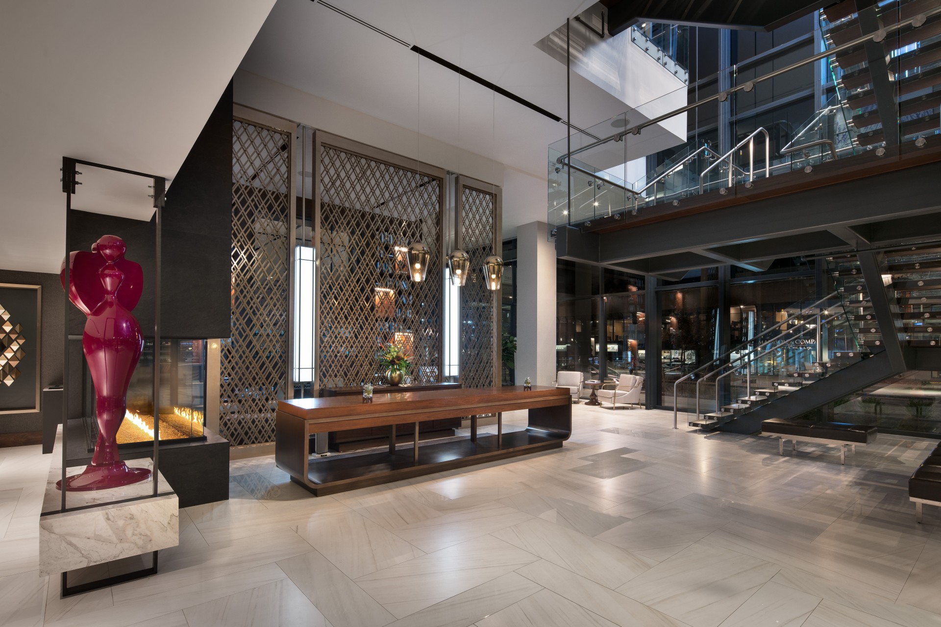 a large hotel lobby with a fireplace and stairs main