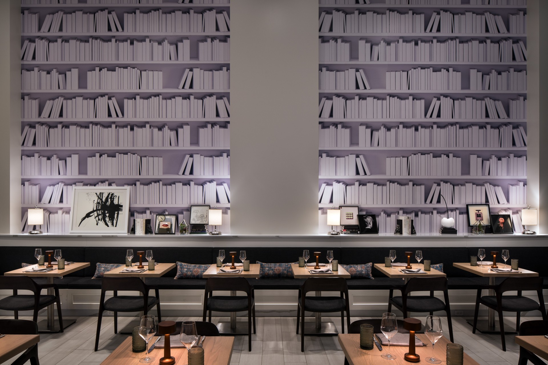 Narrative dining room with tables and chairs and bookshelves