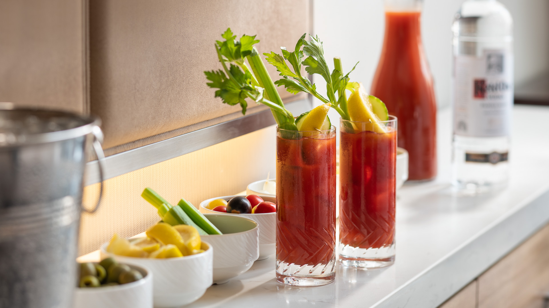 two glasses of bloody mary with celery and lemons