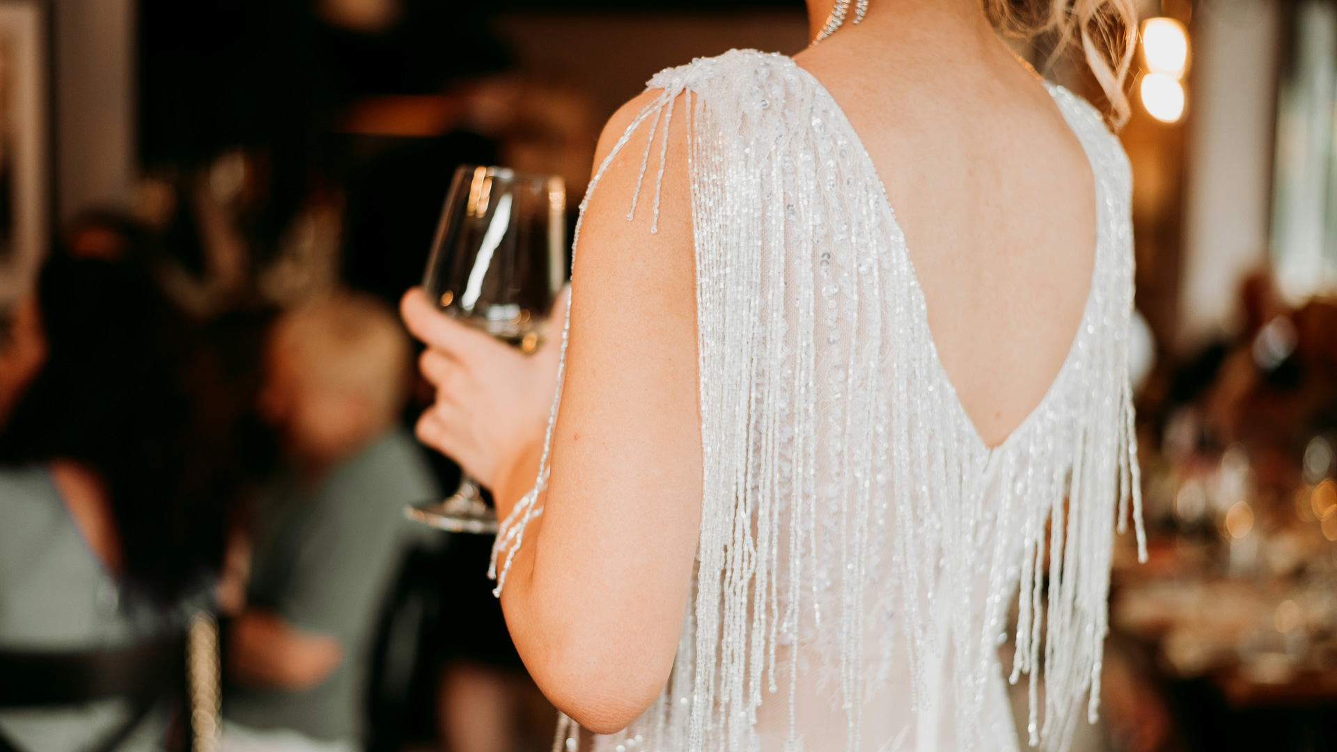 a woman in a white dress holding a wine glass