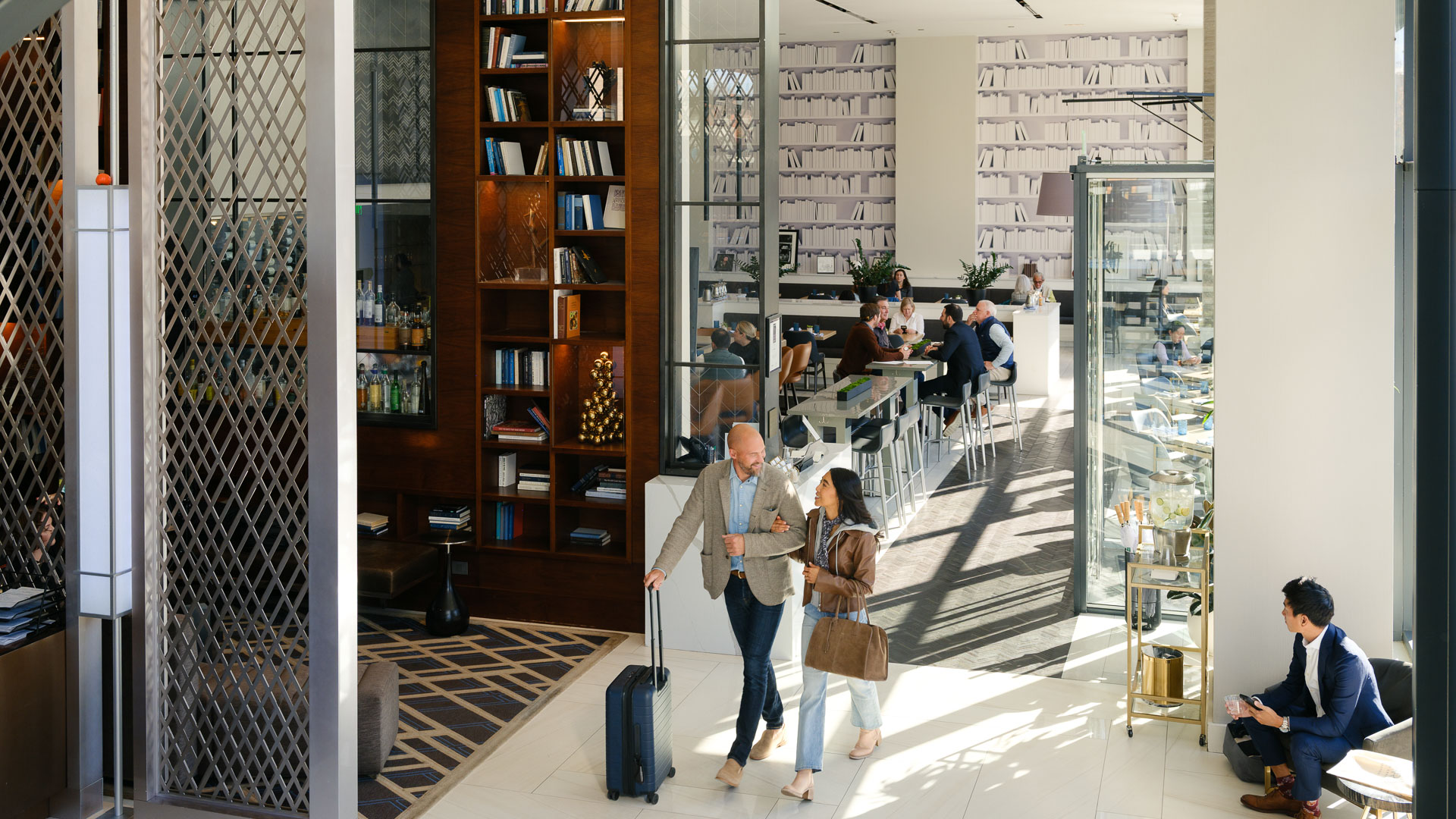 a man and woman walking in a library