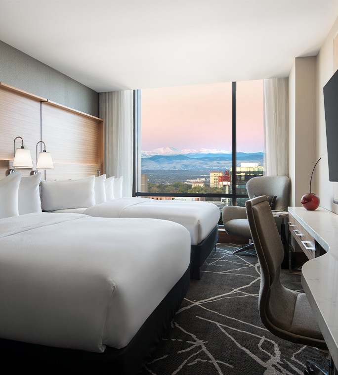 a room with two beds and a television