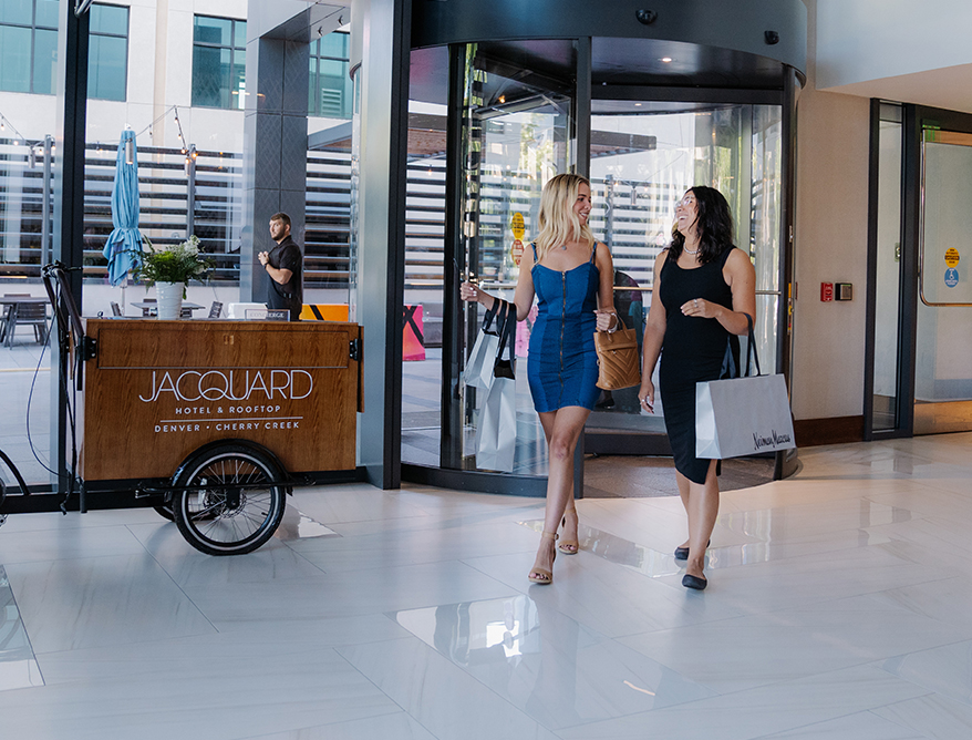 two women walking in a building