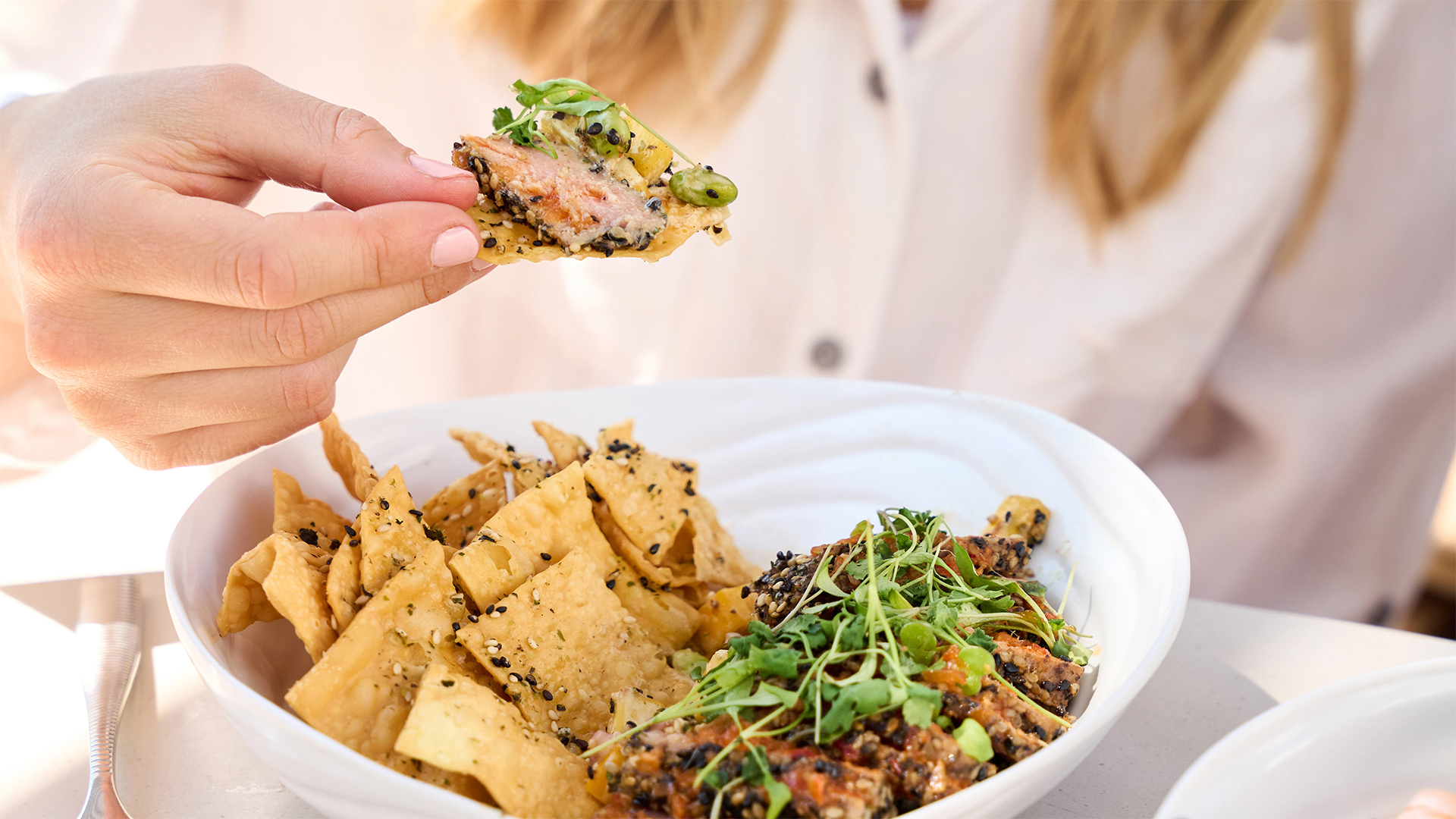 a person holding a chip in their hand main