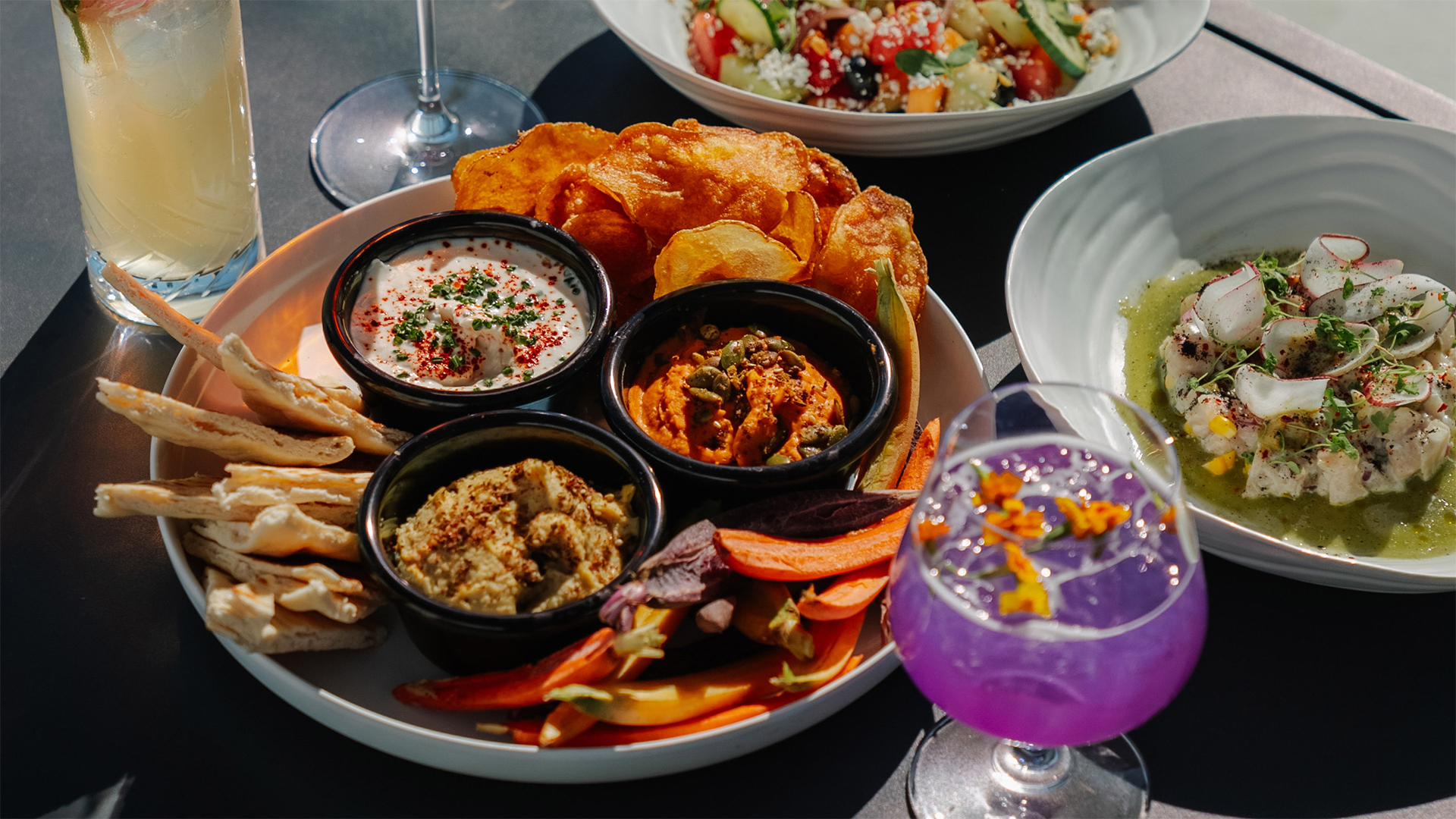 a plate of food with a drink and a glass of liquid main