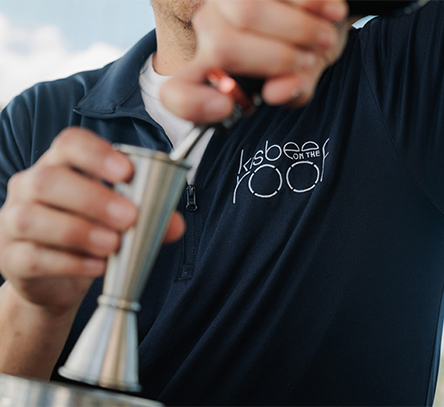 a man pouring a drink into a cup