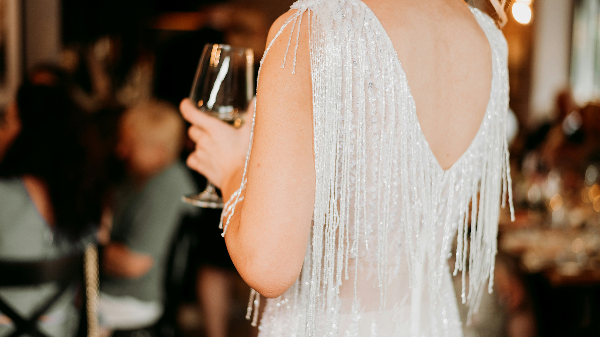 a woman in a white dress holding a wine glass main