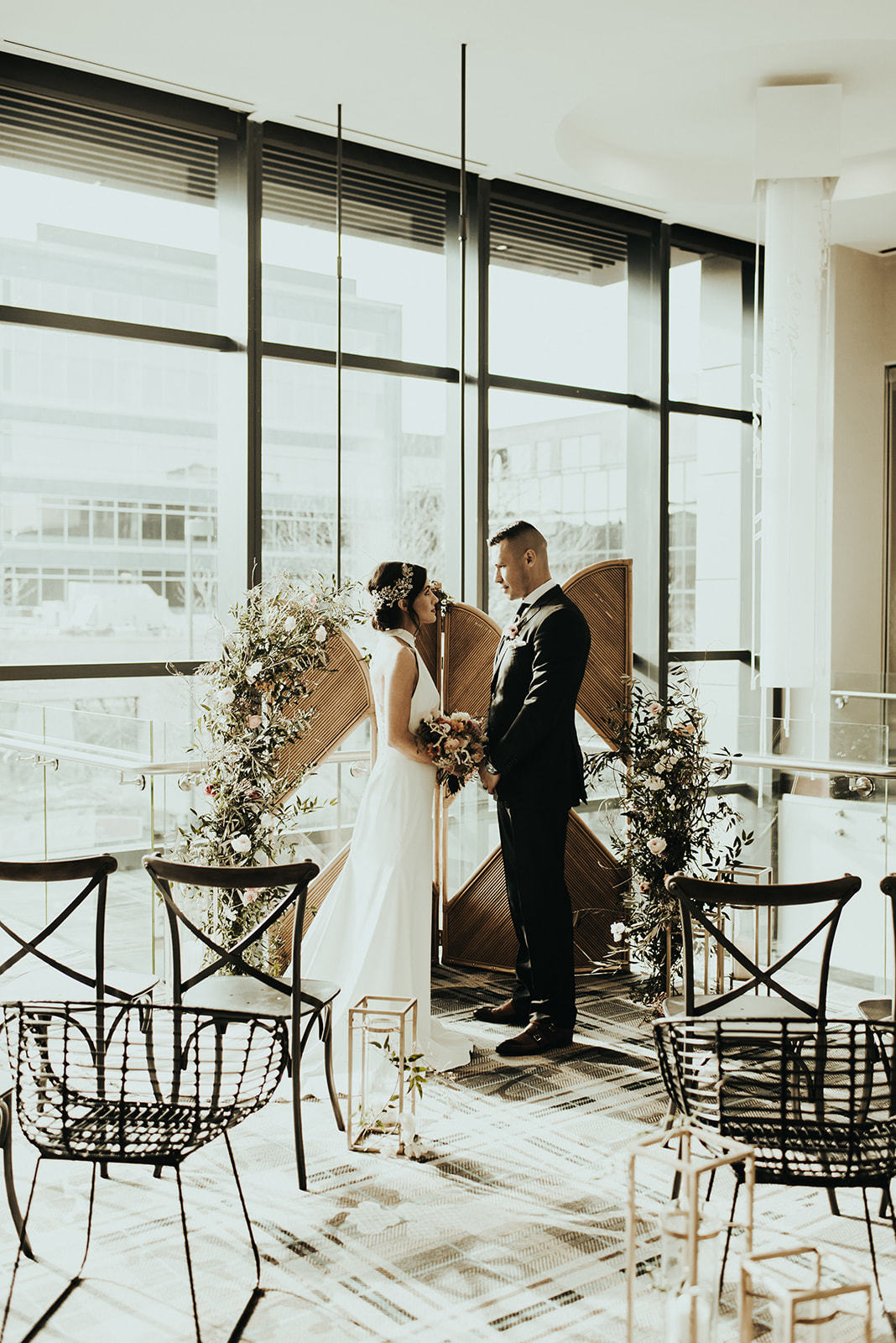 a bride and groom standing in front of a window main