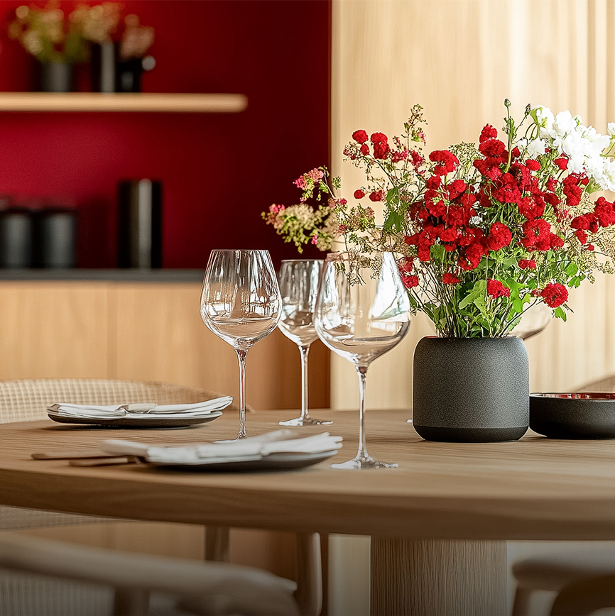 a table with wine glasses and flowers