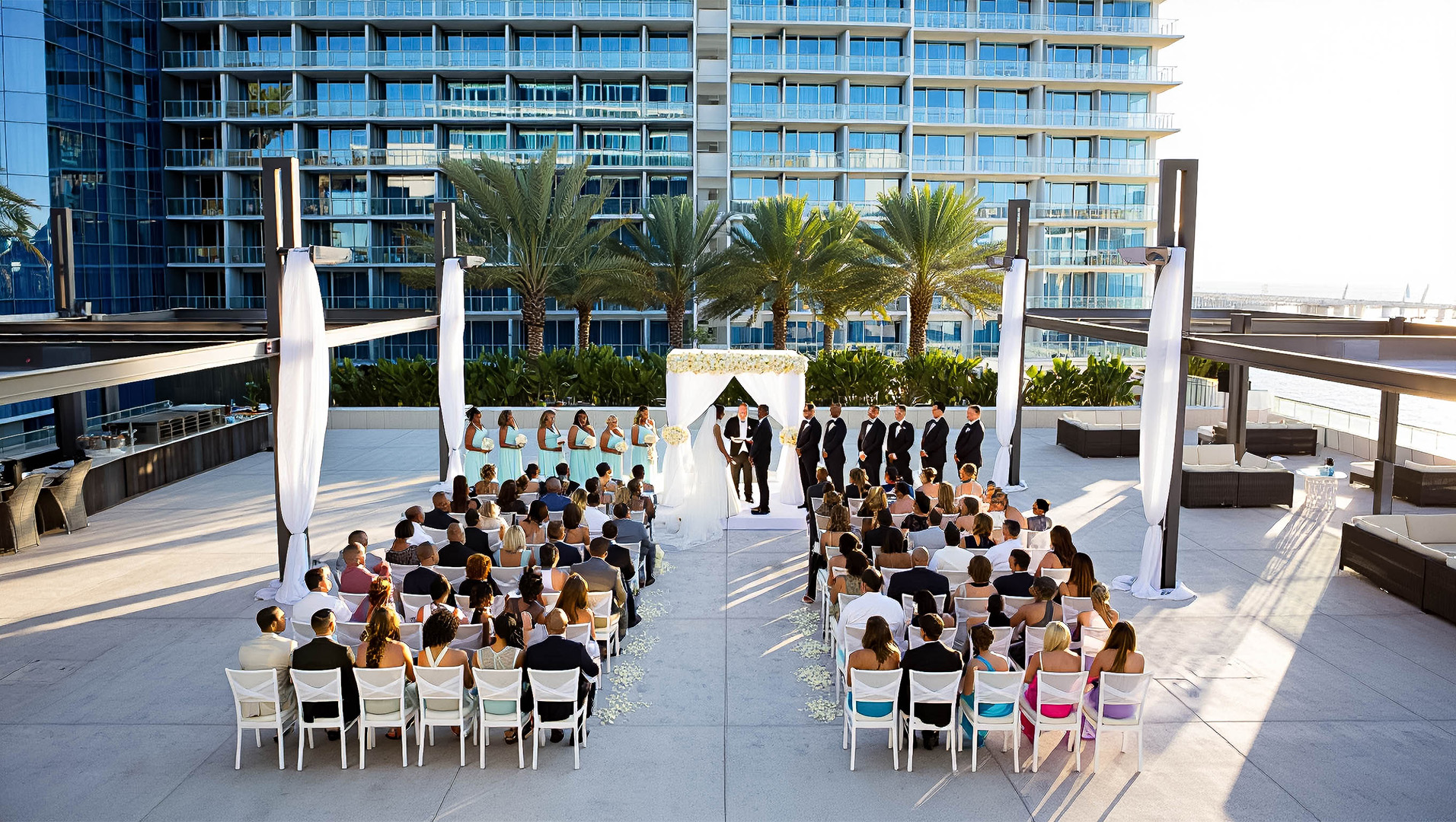 a group of people sitting in chairs and a wedding ceremony