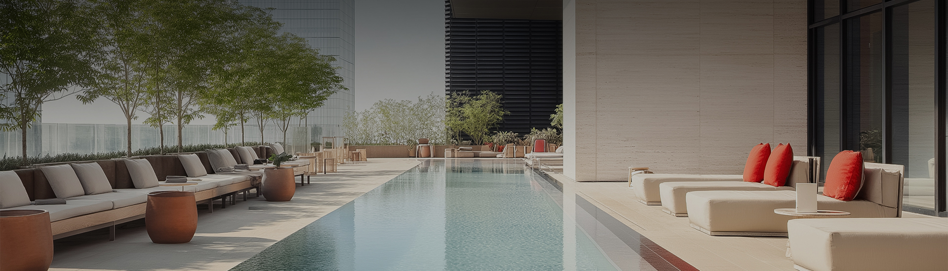 a pool with chairs and a building in the background