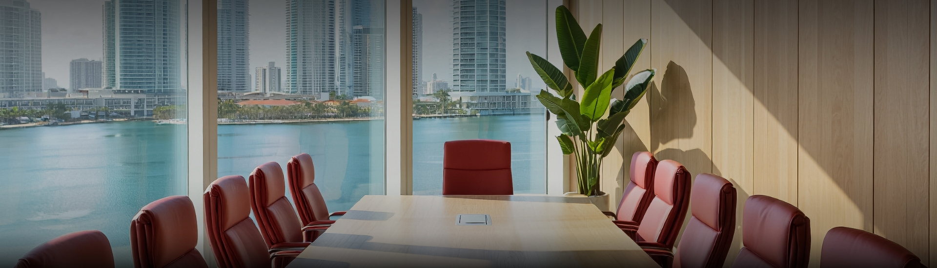 a table with a plant in front of a window overlooking a city