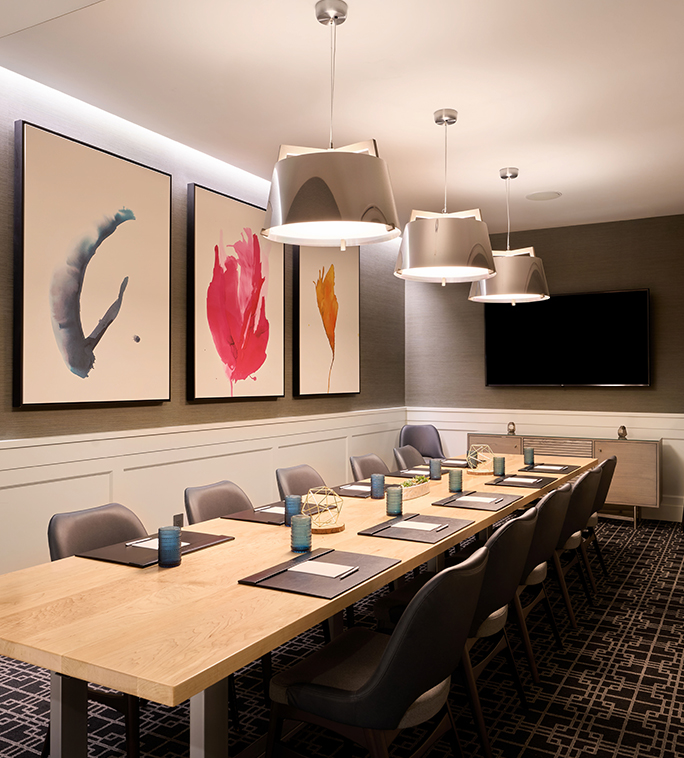 a room with a long table and chairs