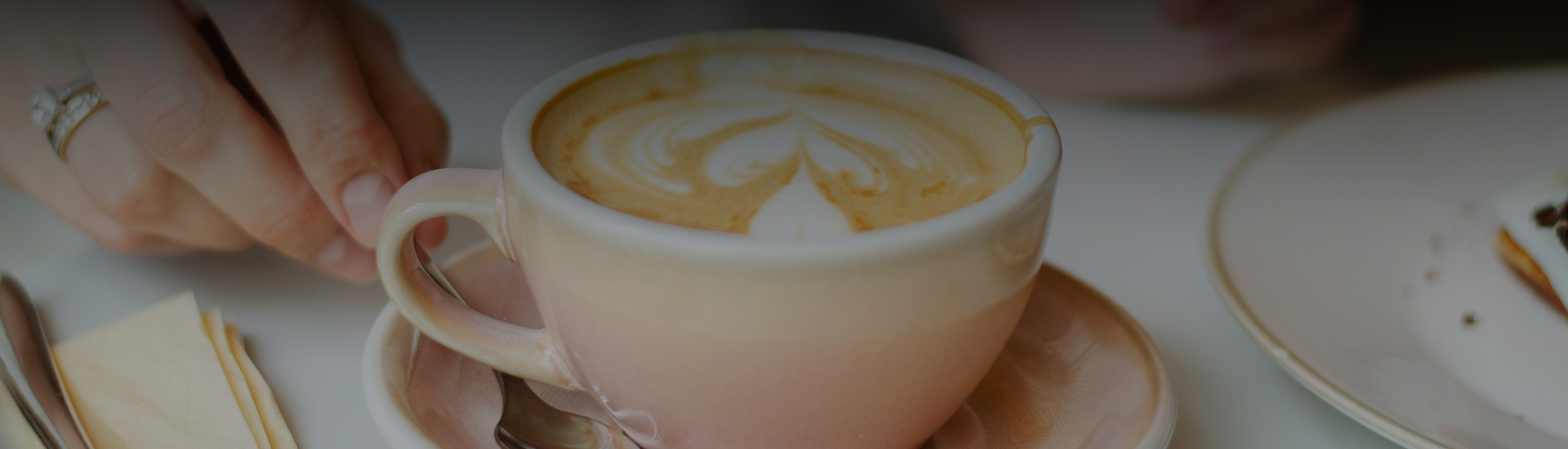 a cup of coffee with a design in the foam