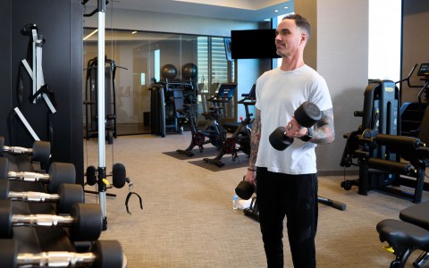 a man holding weights in a gym