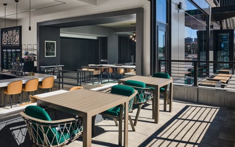 a patio with tables and chairs