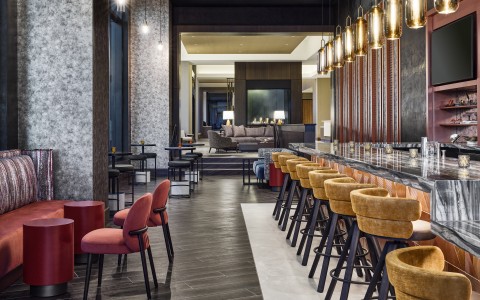 a room with a bar and chairs