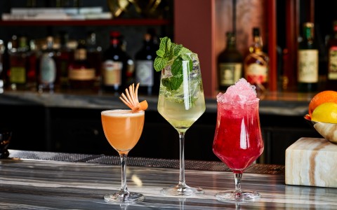 a group of drinks on a bar
